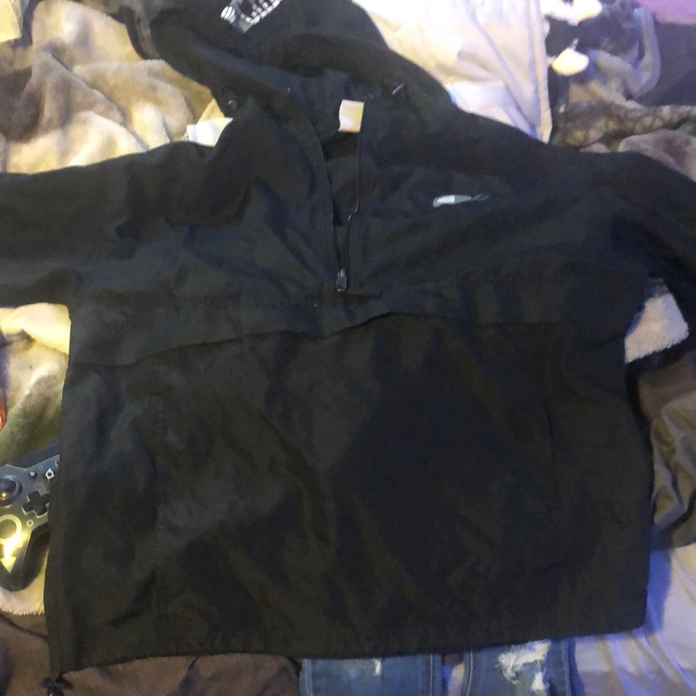 A champion windbreaker, size Medium with a hood drawstring attached